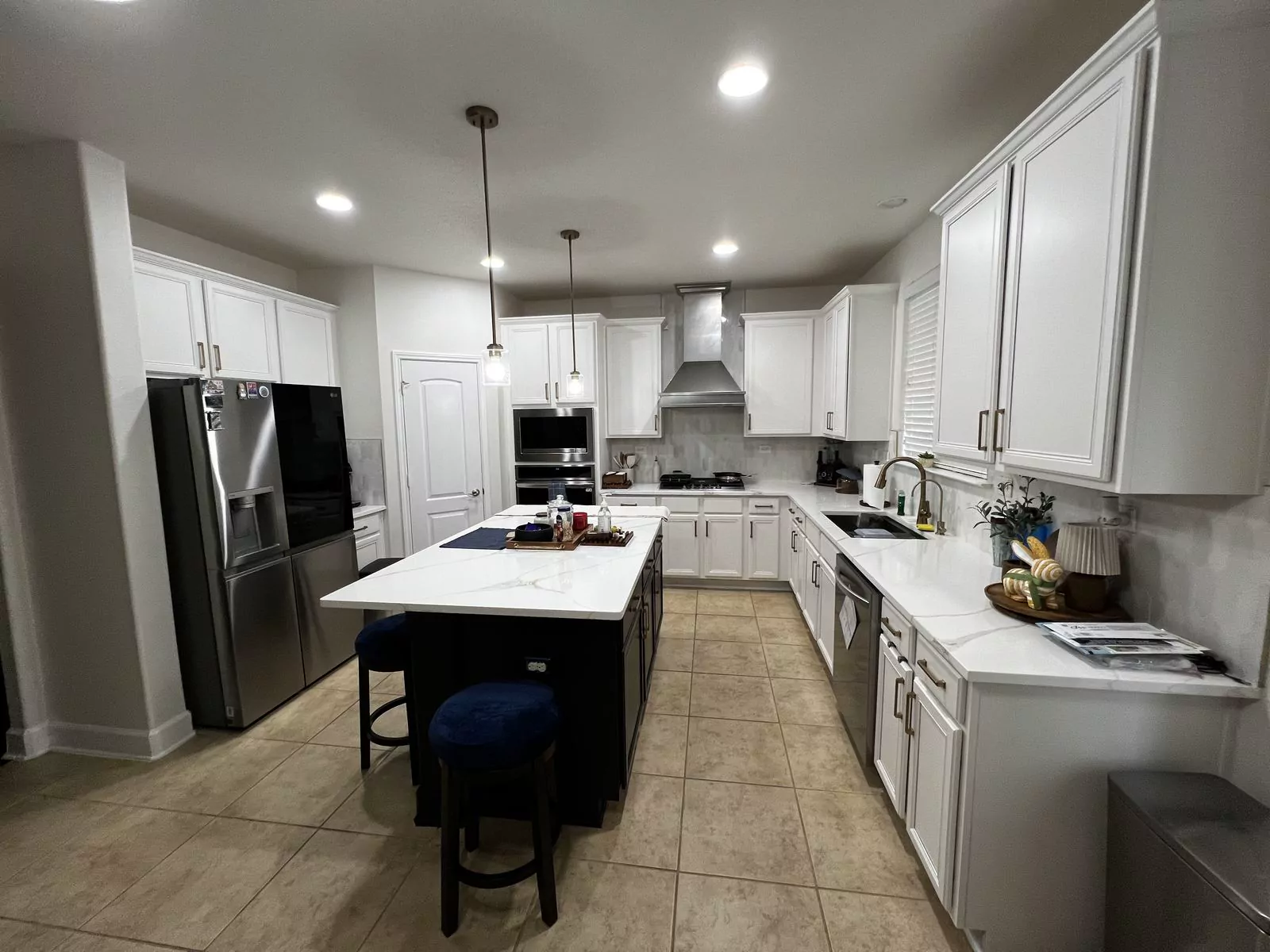 White kitchen, black island by The Flip Fixer