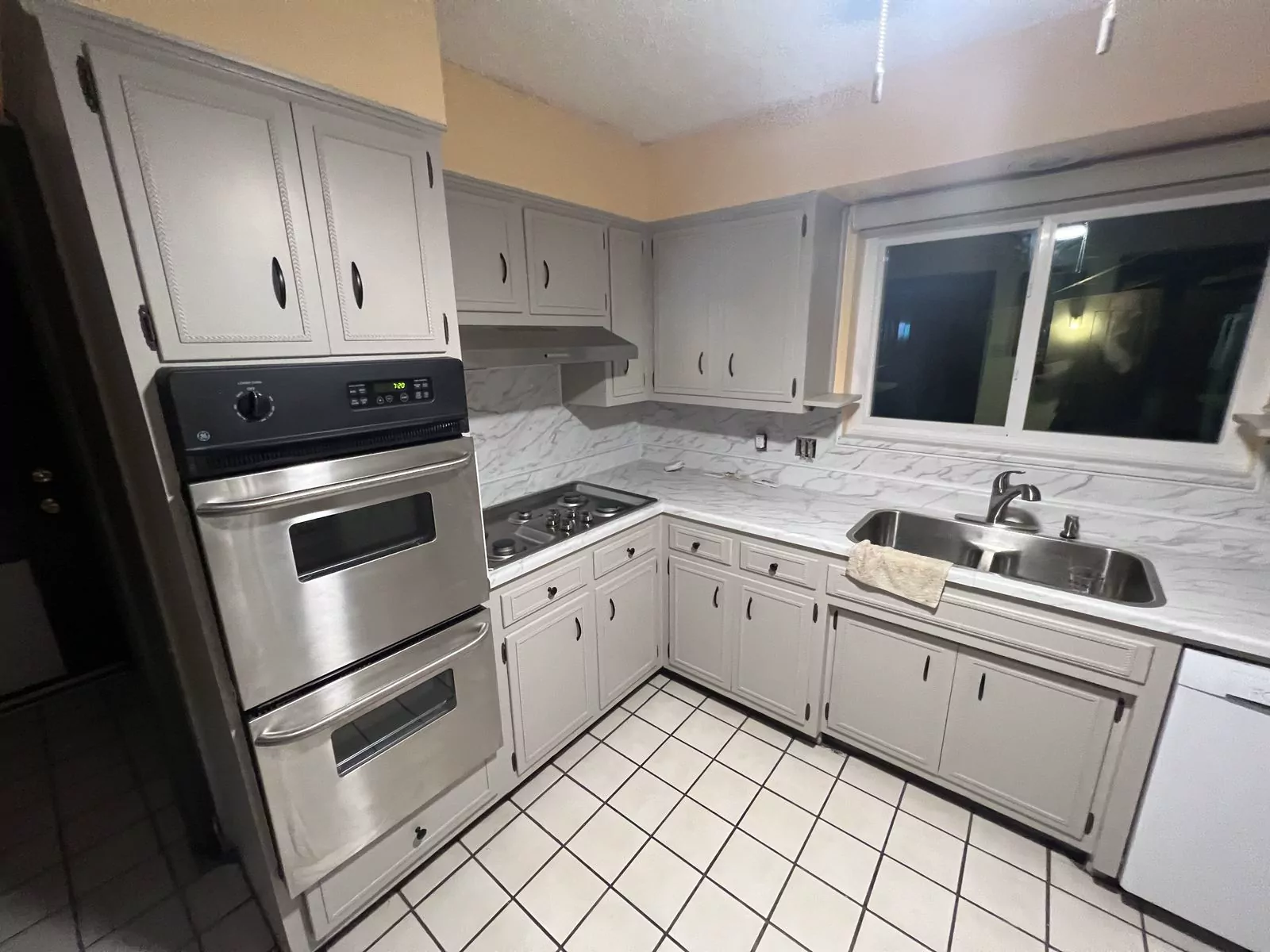 Cream quartz kitchen by The Flip Fixer