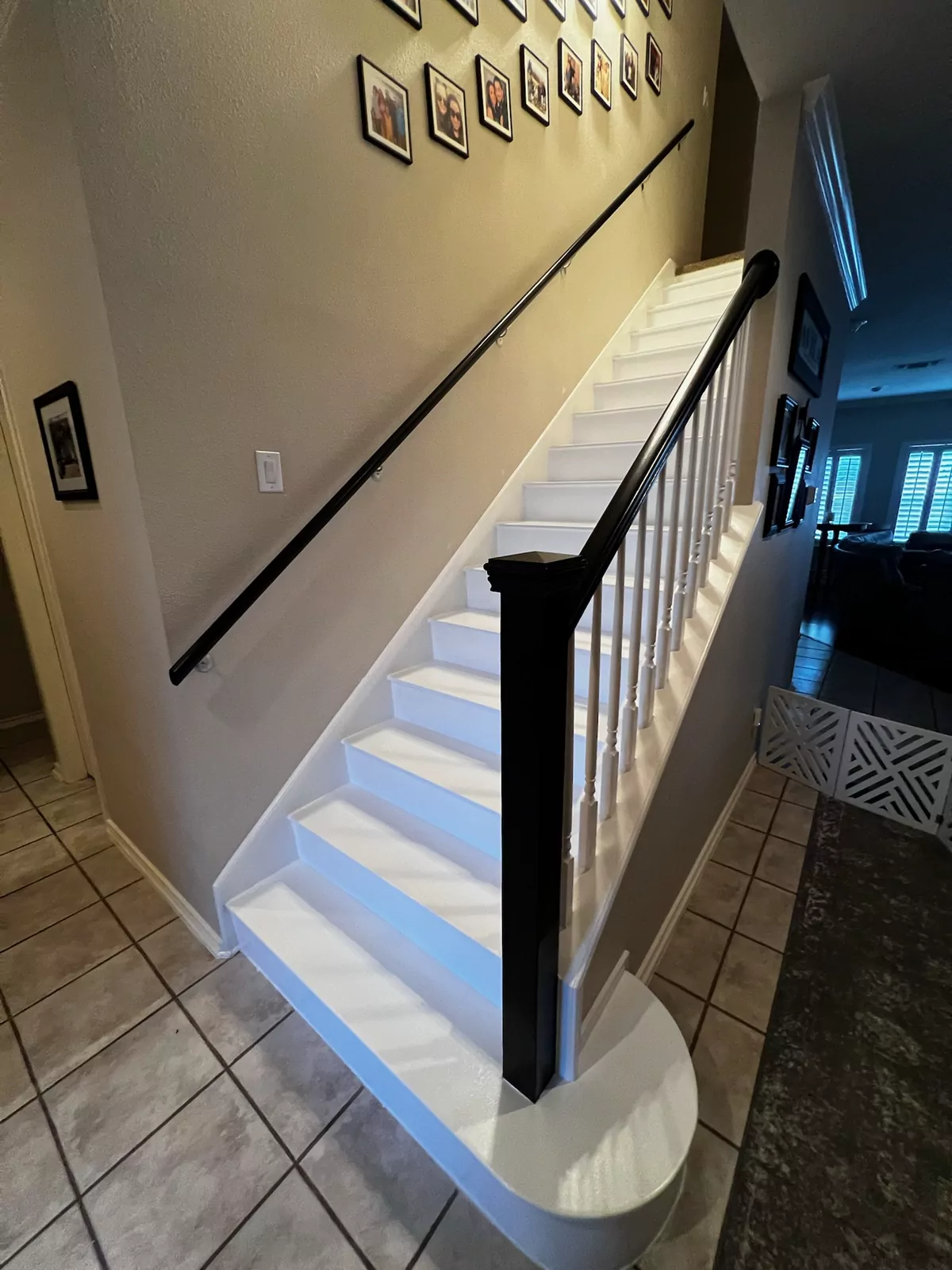 Staircase with wood treads and black rail by The Flip Fixer